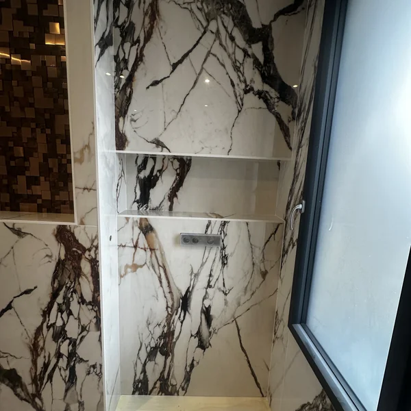 Salle de bain en marbre Calacatta Viola avec mosaïque cuivre